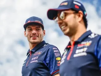 Red Bull drivers Max Verstappen and Sergio Perez share a joke at the 2023 Japanese Grand Prix.